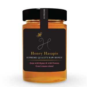 Jar of Honey Hasapis raw honey with a black label on a white background